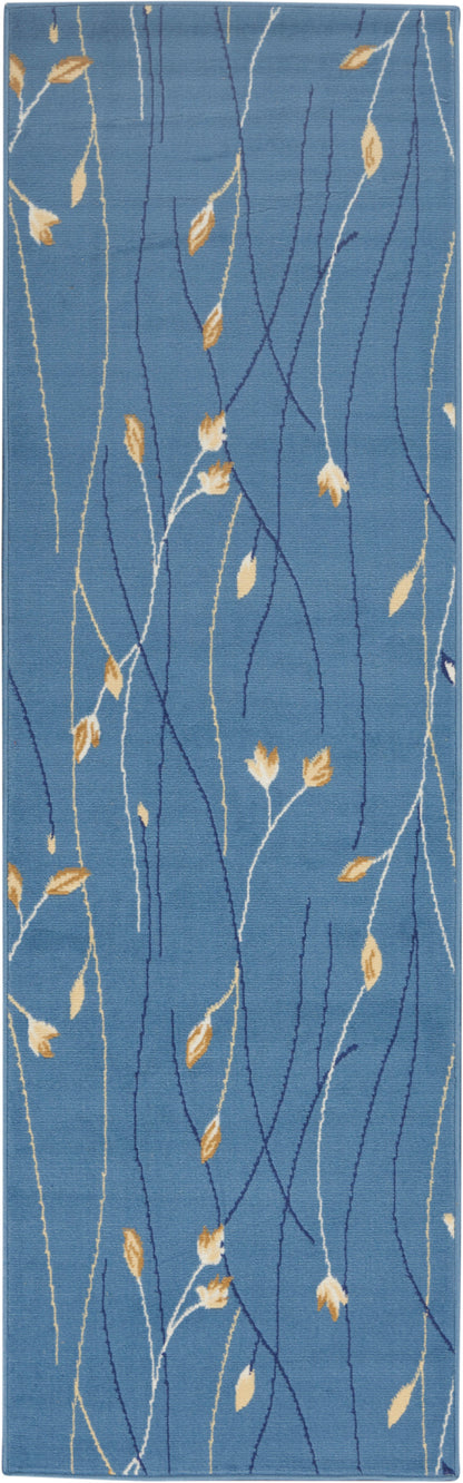 Blue runner rug with white and navy branching stems and golden yellow leaves in a botanical pattern.