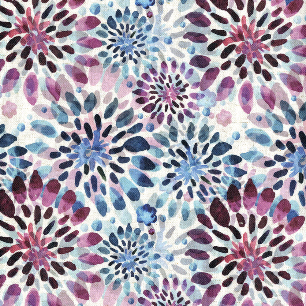Colorful starburst floral print in blues, purples & pinks on white fabric.