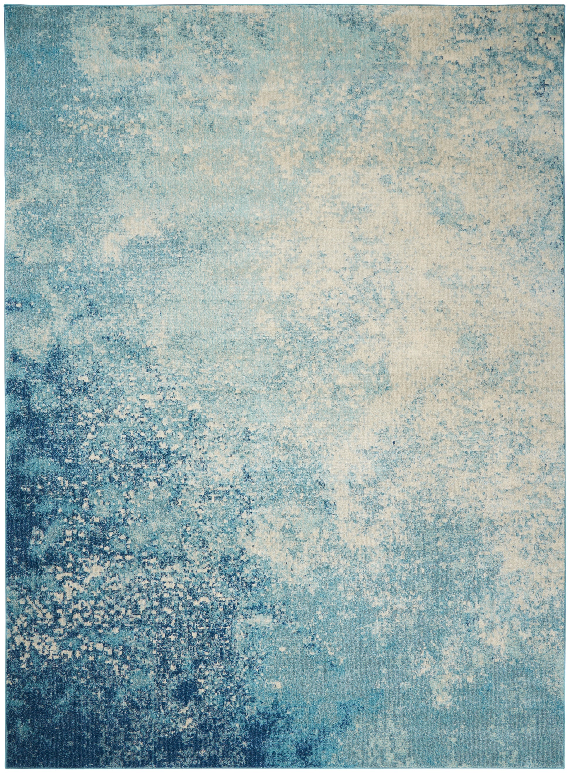 Rectangular blue area rug with teal and ivory speckled, abstract distressed pattern for living room decor.
