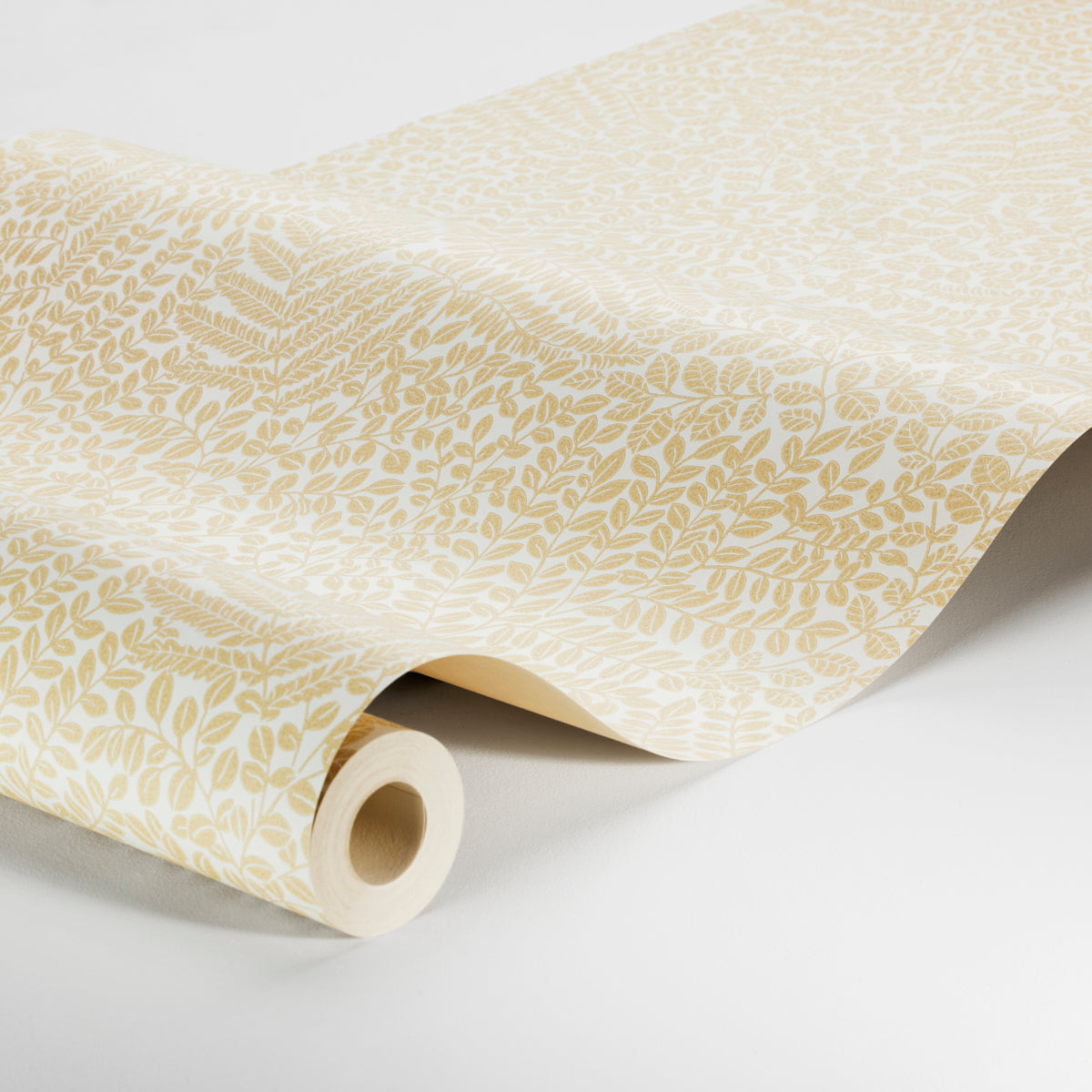 Cream wallpaper with pale beige leaf motif, rolled at the edge.