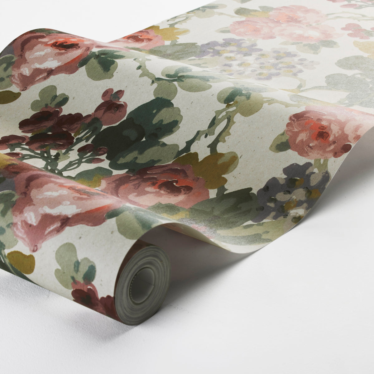 Rolled floral wallpaper with pink, red, and purple blooms and green leaves on a light, natural background.