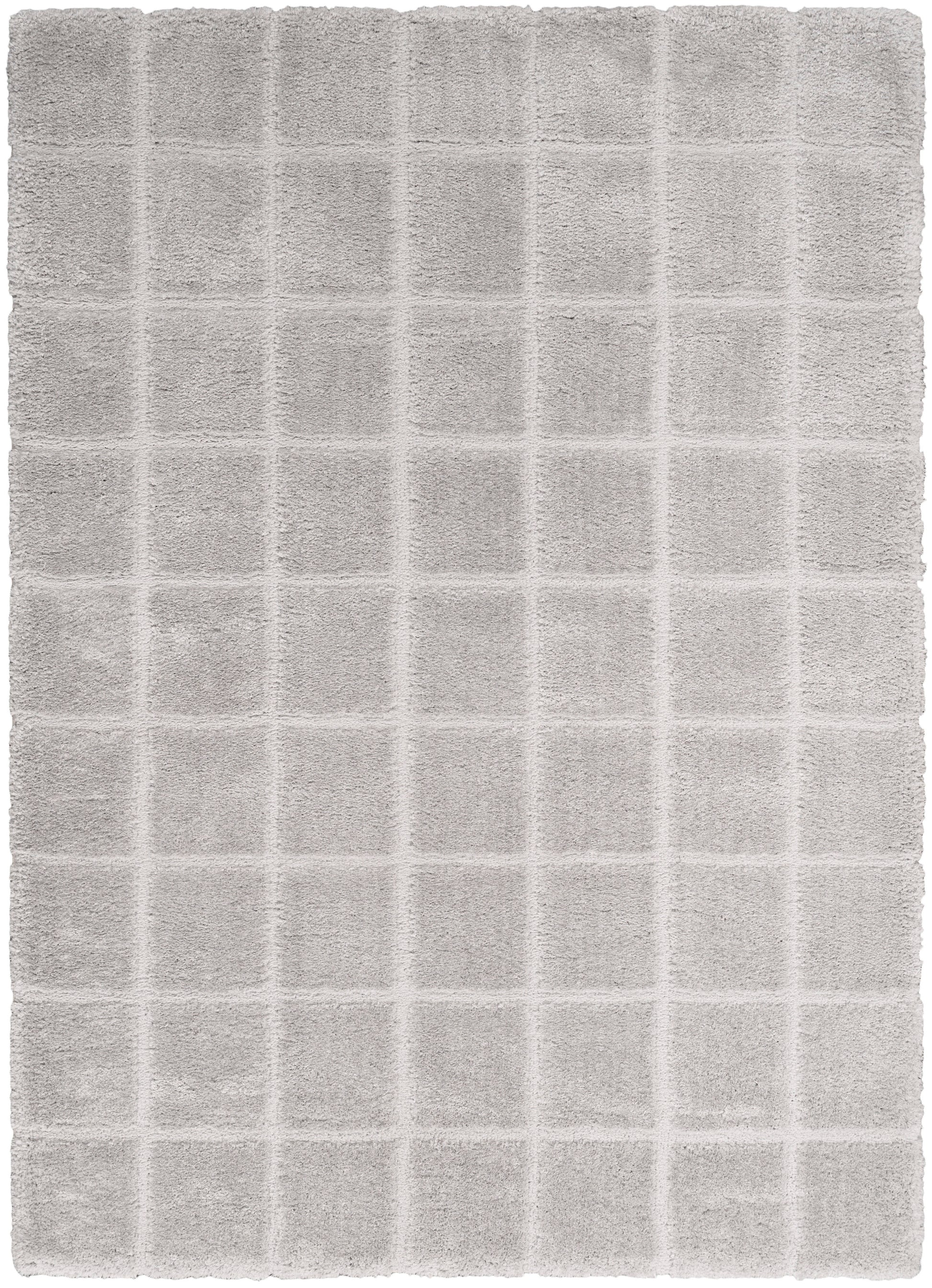 Light gray plush bath rug with a square grid pattern and soft terry texture