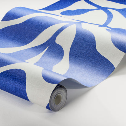 Roll of abstract blue & white wallpaper with large wavy shapes; modern wall decor.