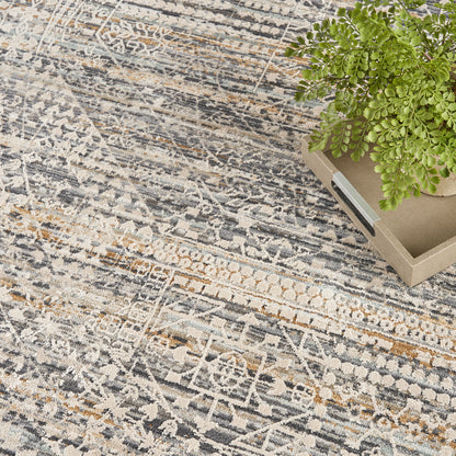 Distressed patterned round area rug in gray, beige and blue tones.