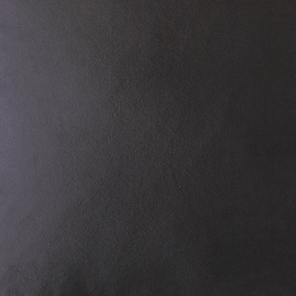 Close-up of dark charcoal suede texture with a subtle purple undertone on a 24" x 24" pillow; solid black.