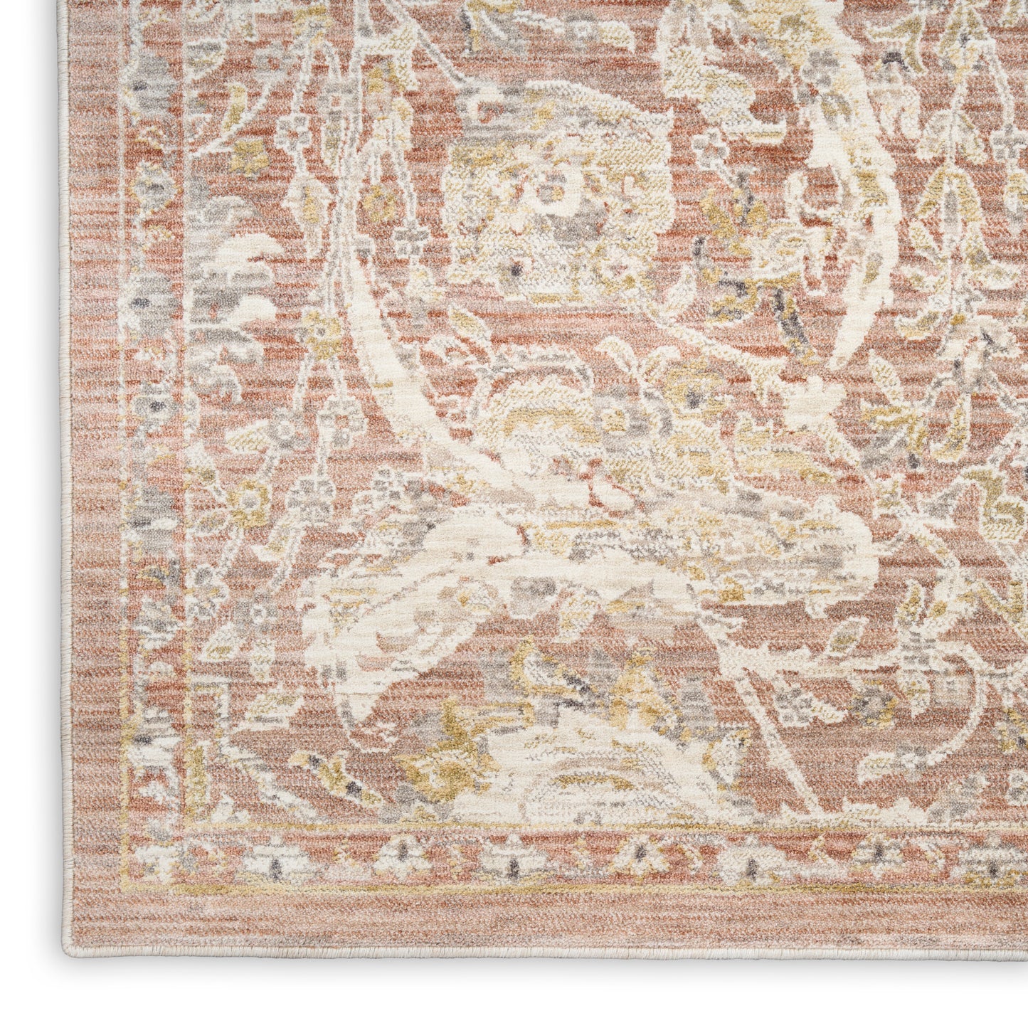 Rectangular distressed pink vintage rug corner with ivory floral medallion, beige and gold accents, woven texture and border.