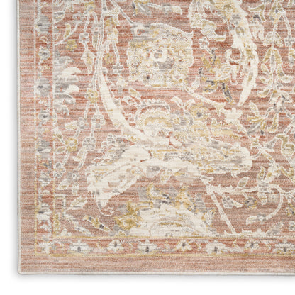 Rectangular distressed pink vintage rug corner with ivory floral medallion, beige and gold accents, woven texture and border.