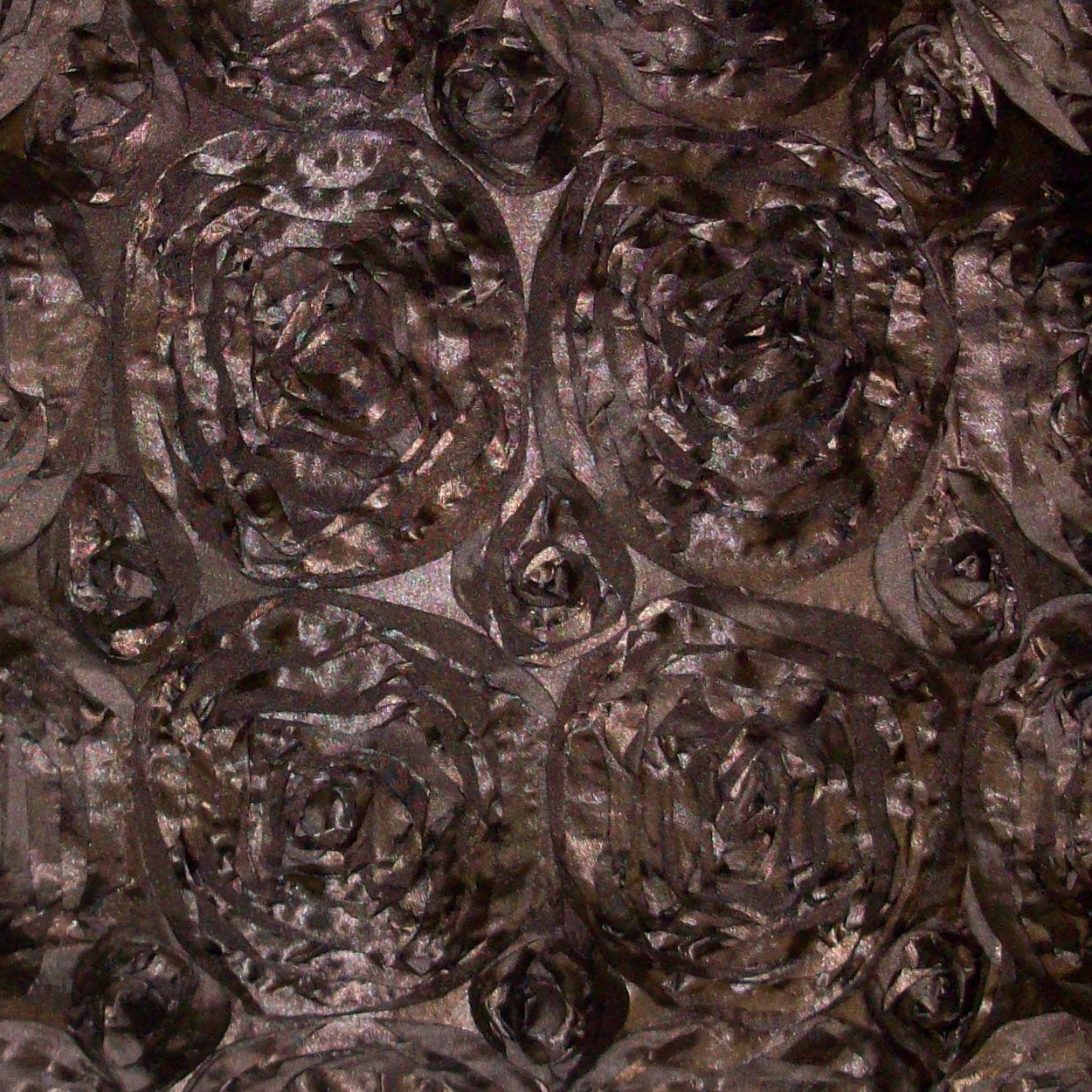 Brown textured pillow featuring a repeating embossed rose rosette motif and subtle sheen, 24" x 24".