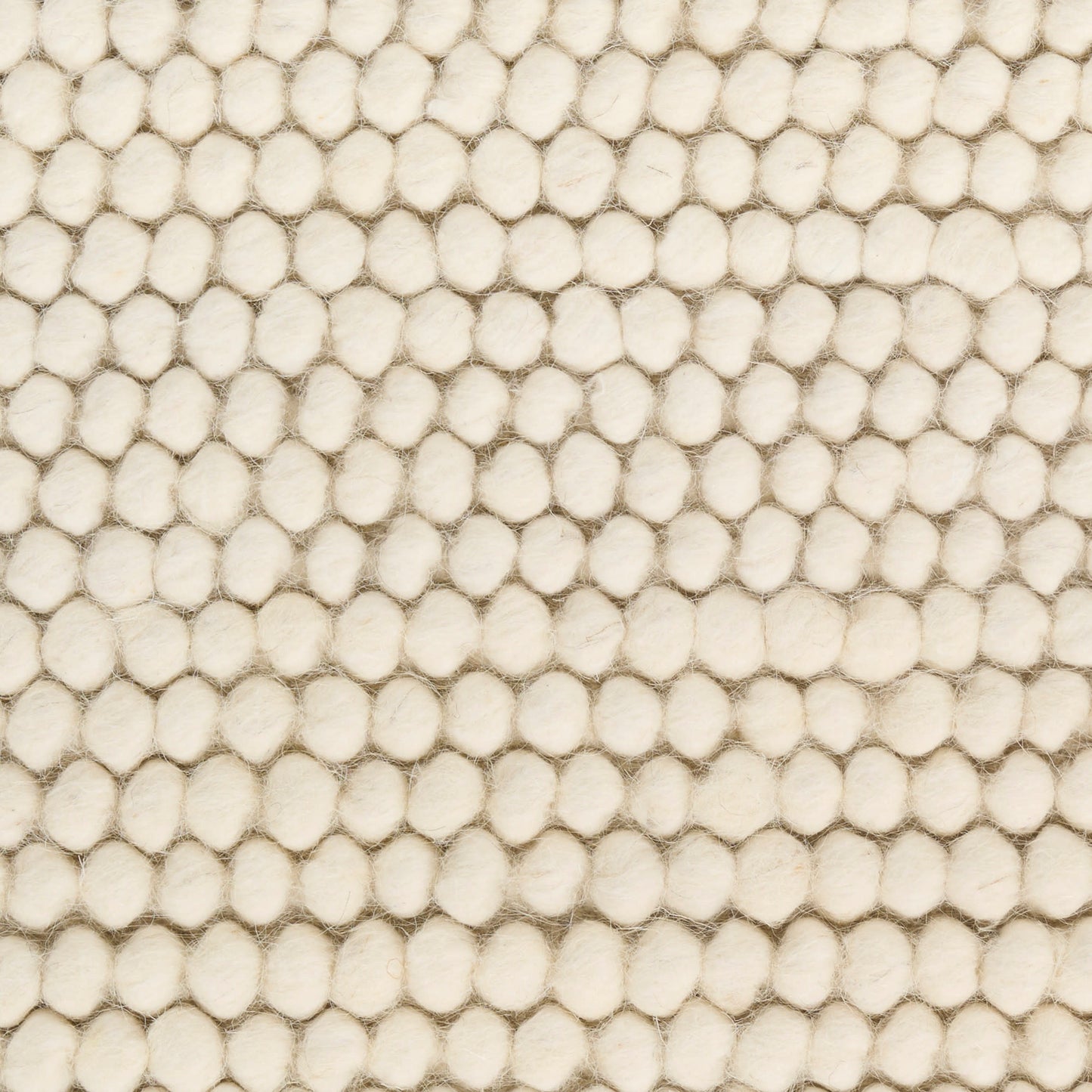 Cream beige boucle fabric closeup with dense rounded loops and a soft, textured rug.