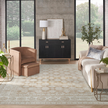 Bright living room with large windows, black sideboard & gold handles, beige sofa, caramel armchair, patterned rug.