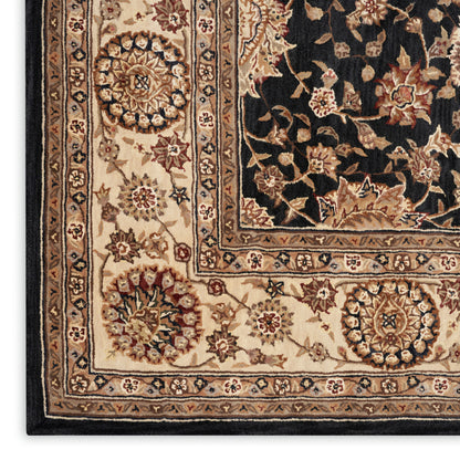 Rectangular traditional Oriental rug with beige border, black field and floral medallions in ivory, gold and brown.