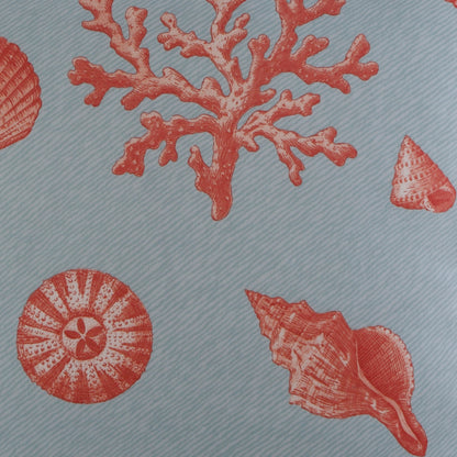 Pillow cover: light blue fabric with red coral and seashell prints and a diagonal striped texture.