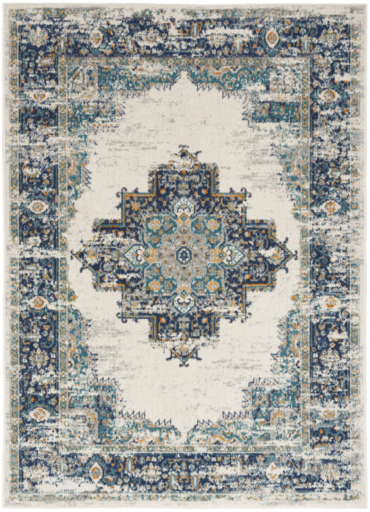 Rectangular distressed oriental area rug with a central medallion in navy, teal and ivory; ornate border, vintage look.