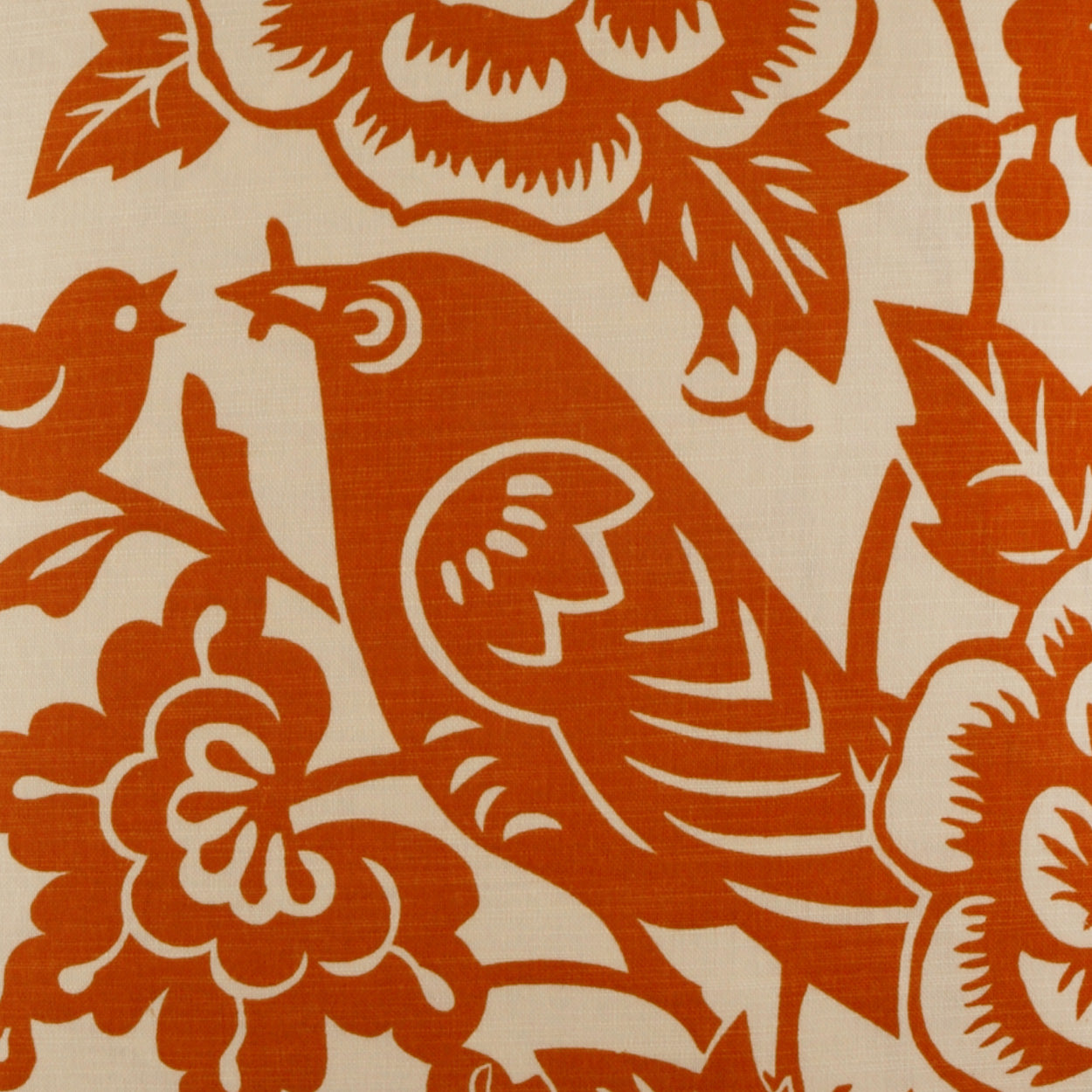 Orange bird and floral pattern on cream pillow fabric; bold, stylized bird among large blossoms and leaves.