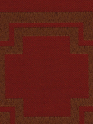 Geometric red-on-brown upholstery fabric with a stepped border and square central motif, textured surface.