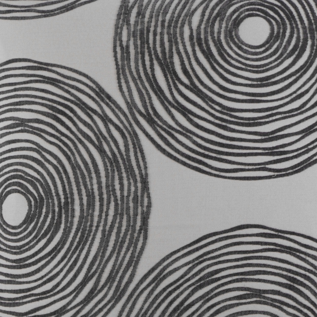 Charcoal gray pillow with bold black concentric circles and abstract circular dot motif.