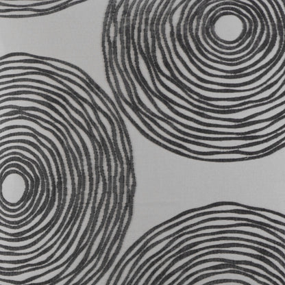 Charcoal gray pillow with bold black concentric circles and abstract circular dot motif.