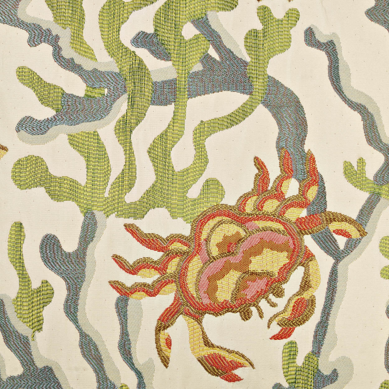 Tapestry-style fabric pattern featuring an orange crab among green seaweed on a cream background.