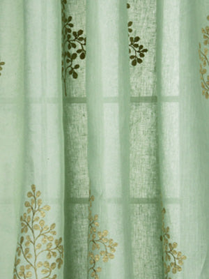 Mint green sheer curtain with gold-brown botanical embroidery and vertical pleat folds.