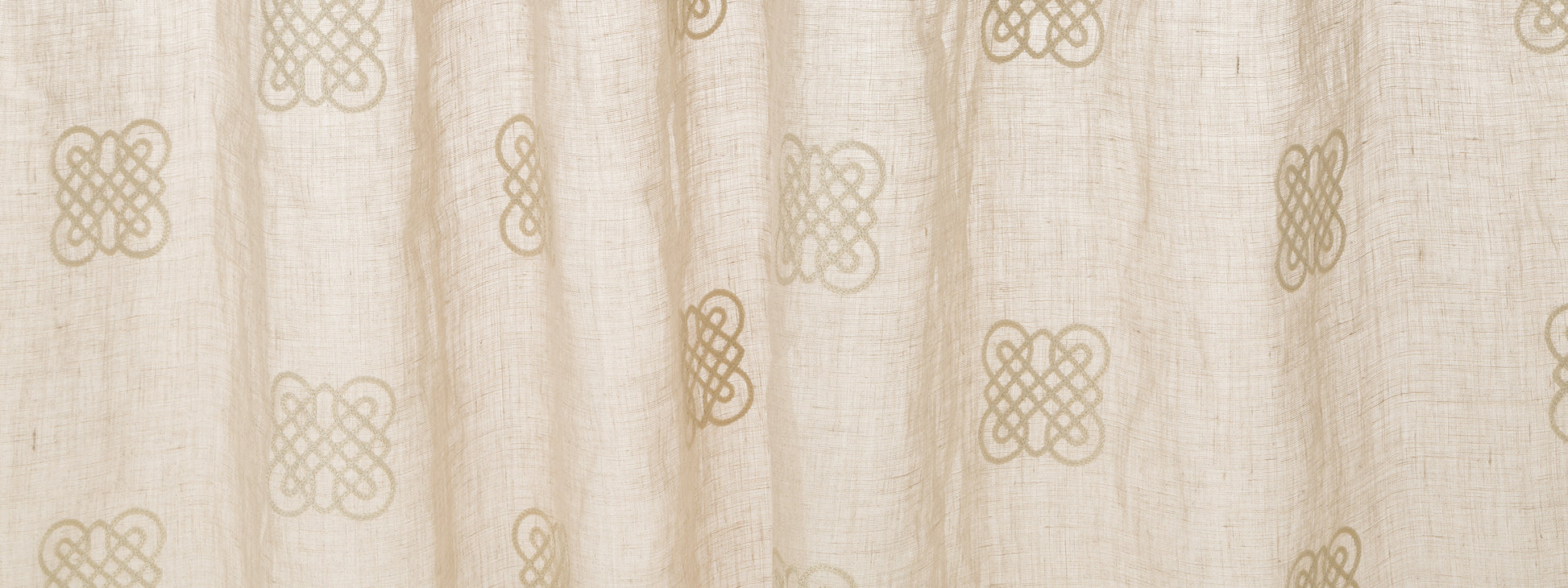 Cream curtain fabric with tan interlocking knot motifs; soft drape for window decor.