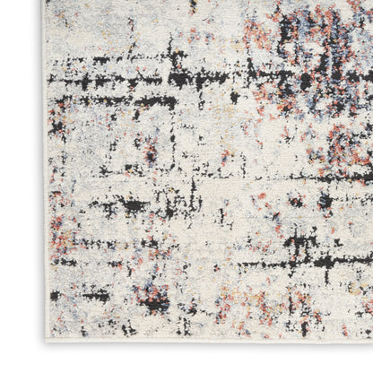 Cream distressed abstract rug with black, rust and light blue specks; modern, textured weave.