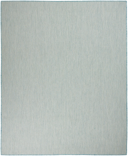 Rectangular pale gray rug with a tiny blue dot pattern and teal border.
