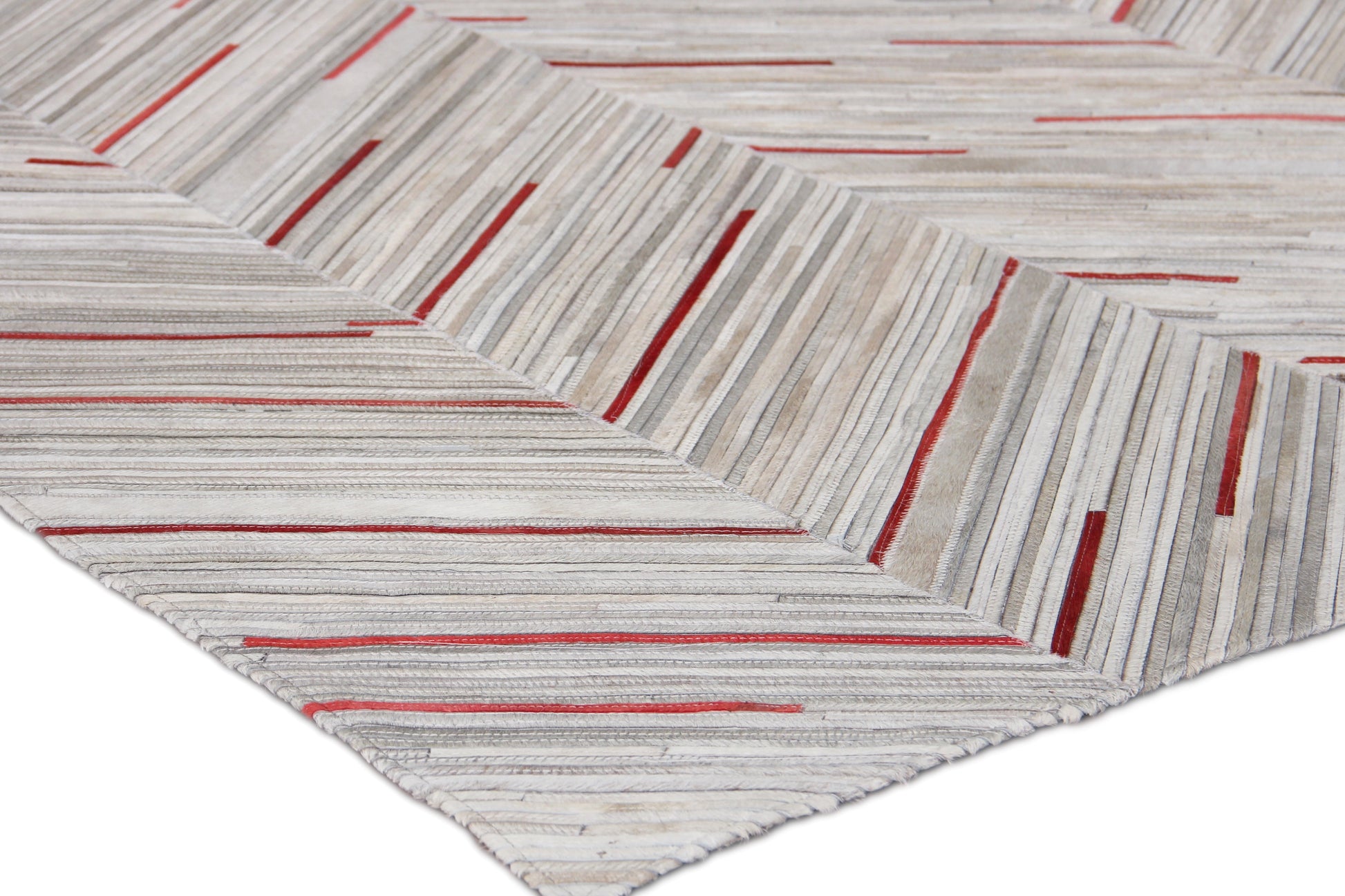 Natural hide indoor hand-stitched rug in light gray with thin red stripes forming chevron blocks; textured modern floor decor.