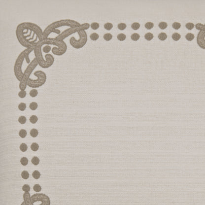 Beige linen-like fabric pillow with taupe embroidered dotted border & decorative corner scroll motif.