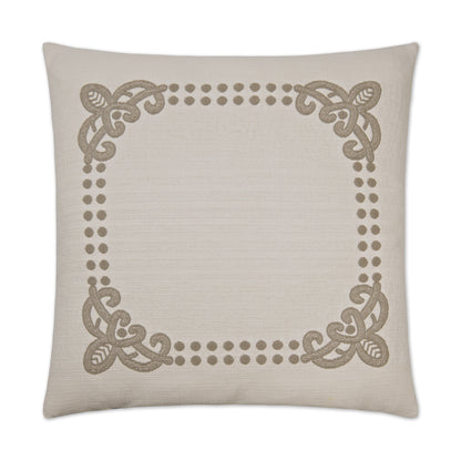 Beige linen-textured square pillow with taupe ornamental corner scrolls and a dotted border.