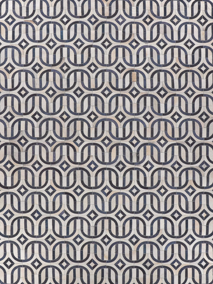 Natural hide rug with hand-stitched detailing; warm neutral tones and visible hide texture.