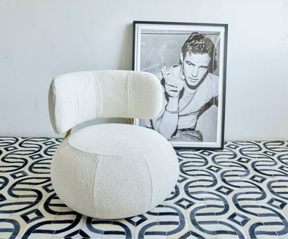 Natural hide indoor hand-stitched rug, 5' x 8', in a geometric tiled room with a framed monochrome art print.