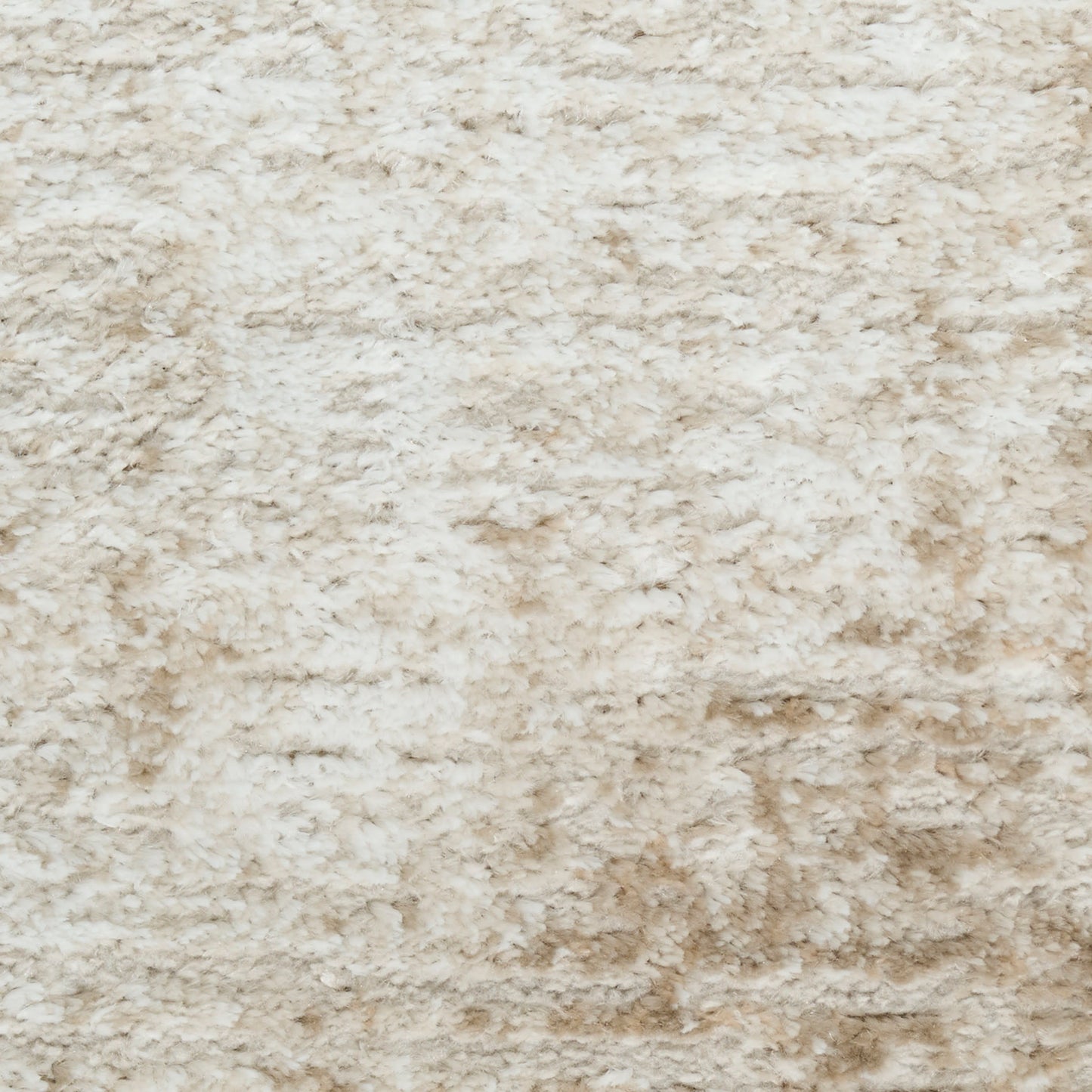 Cream beige shag rug with plush, high-pile texture for cozy decor.