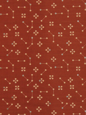 Burnt orange fabric with white geometric circuit-like lines and small flower-shaped dot clusters.
