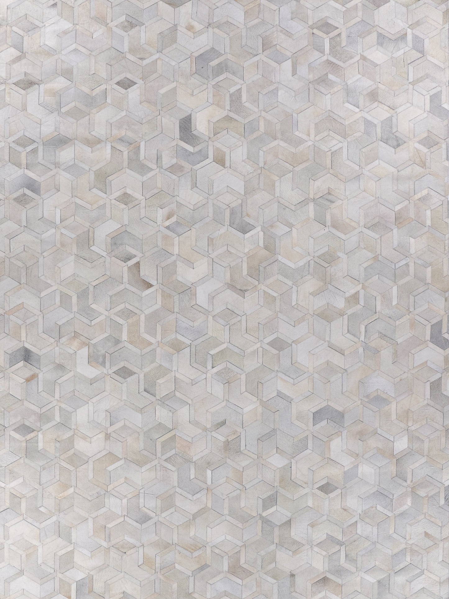 Natural hide indoor rug, hand stitched, in neutral beige, taupe and gray tones, size 5' x 8'.