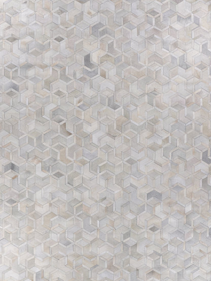 Natural hide indoor rug, hand stitched, in neutral beige, taupe and gray tones, size 5' x 8'.