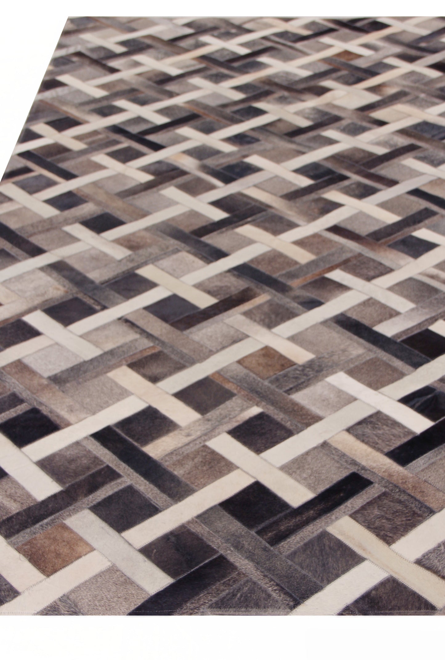 Natural hide indoor hand-stitched rug with a geometric lattice motif in cream and charcoal tones.