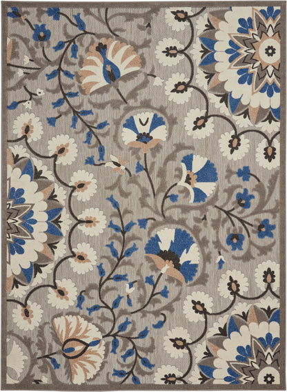 Floral area rug with taupe background, blue, white and beige blossoms on curling brown vines.
