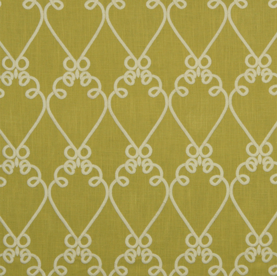 Wall sconce with olive-yellow fabric shade featuring a white interlocking looping lattice trellis pattern.