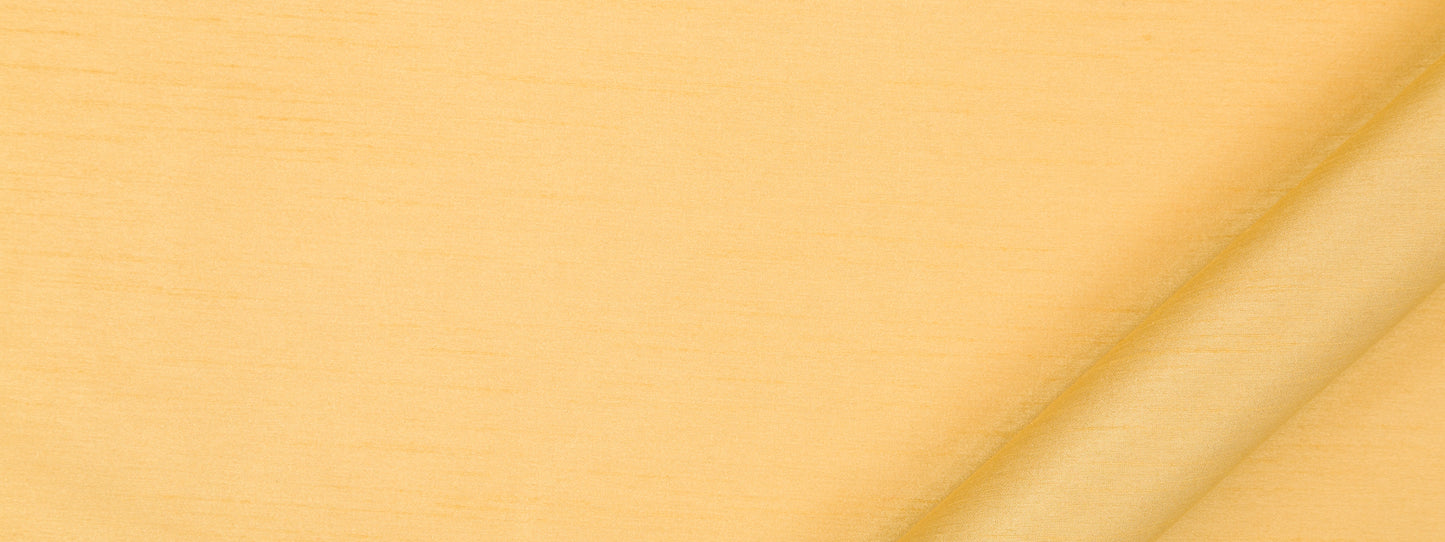 Soft yellow fabric with a diagonal fold and subtle texture.