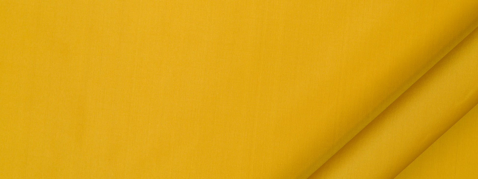 Bright yellow fabric close-up with folded corner and diagonal shadows, versatile for clothing or home decor.