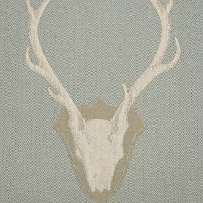 Pillow with a white deer skull and large antlers on a pale blue woven backdrop, 24 x 24 inches.
