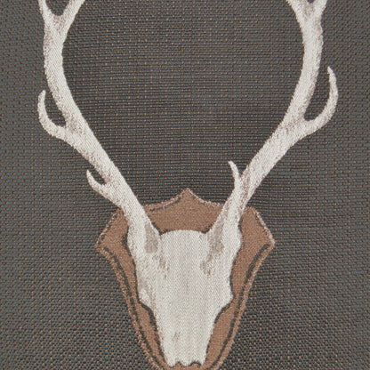 Grey pillow featuring a white deer skull with antlers and a tan shield outline on woven fabric.