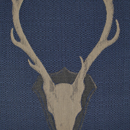 Navy blue pillow with beige deer skull & antlers motif on a woven textile, 24" x 24".
