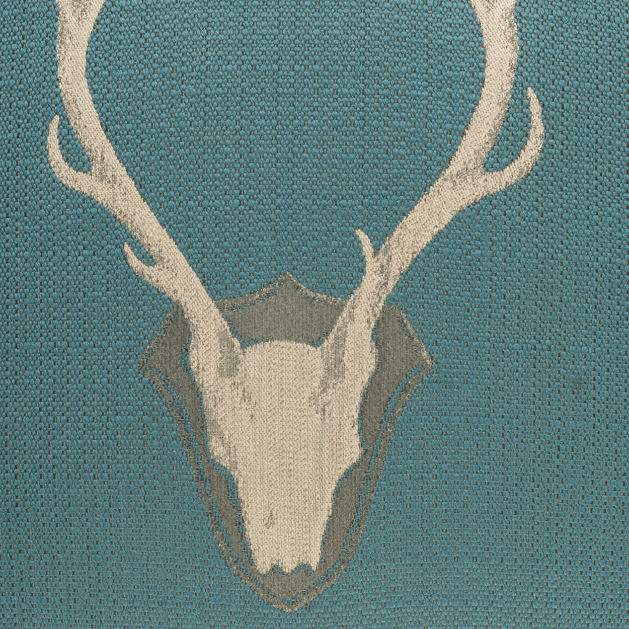 Teal woven textile featuring a pale deer skull & large antlers, rustic wildlife motif.