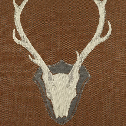 Brown woven pillow featuring a beige deer skull with white antlers on a textured background.