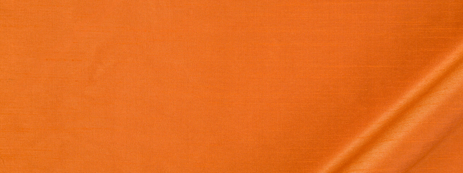Orange satin fabric with subtle sheen and a diagonal fold at the bottom right.