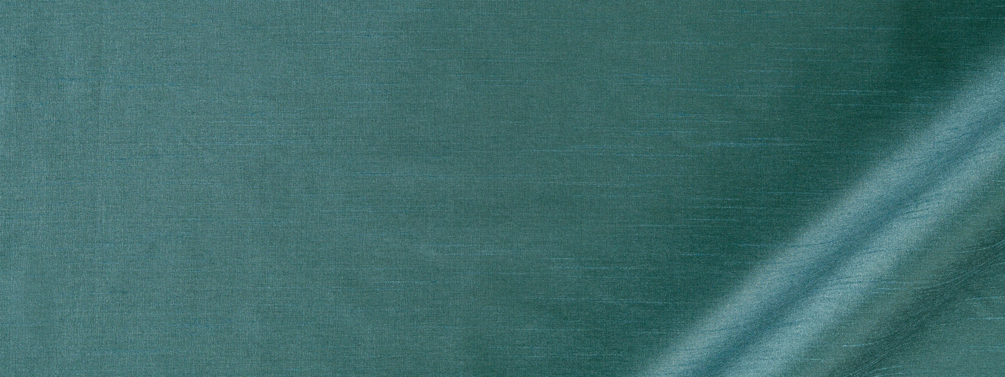 Teal-green linen-like fabric texture with a subtle weave and a diagonal fold along the bottom-right.