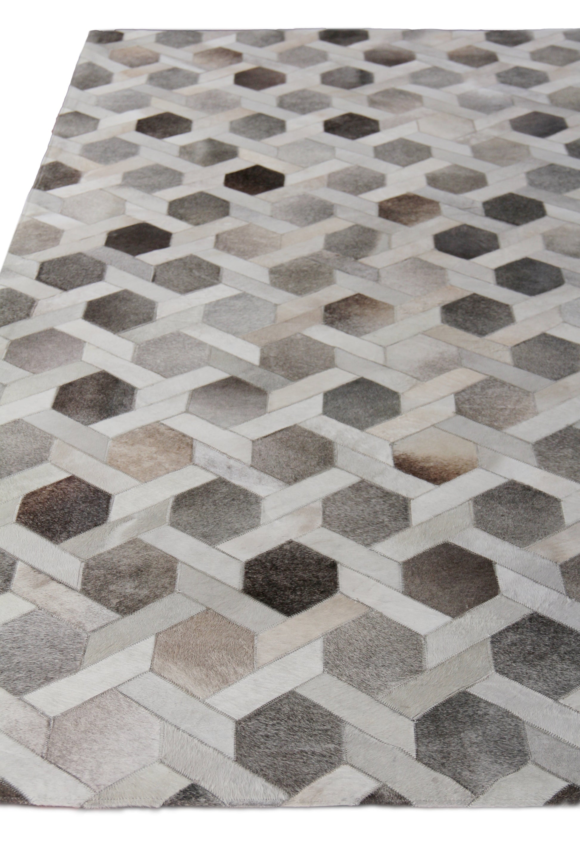 Natural hide indoor hand-stitched rug with a geometric interlocking 3D hexagon cube pattern in gray, beige and brown tones, 5' x 8'.