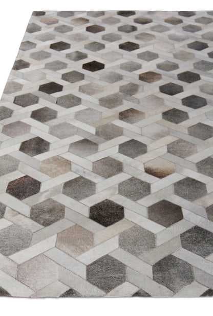 Natural hide indoor hand-stitched rug with a geometric interlocking 3D hexagon cube pattern in gray, beige and brown tones, 5' x 8'.