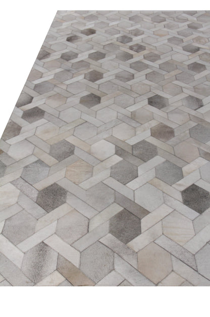Natural hide rug for indoor use, hand-stitched, in neutral beige, taupe and brown tones; 5' x 8'.